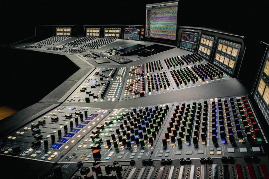 SSL Odyssey large-format analog mixing console with multiple control screens and motorized faders.